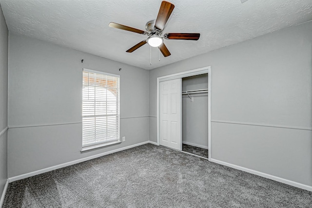 unfurnished bedroom featuring a ceiling fan, baseboards, carpet floors, a closet, and a textured ceiling