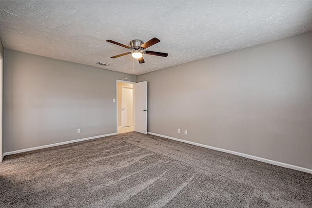 carpeted empty room featuring a textured ceiling, a ceiling fan, visible vents, and baseboards