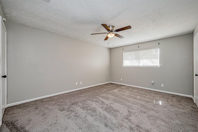 empty room with carpet flooring, a textured ceiling, baseboards, and ceiling fan