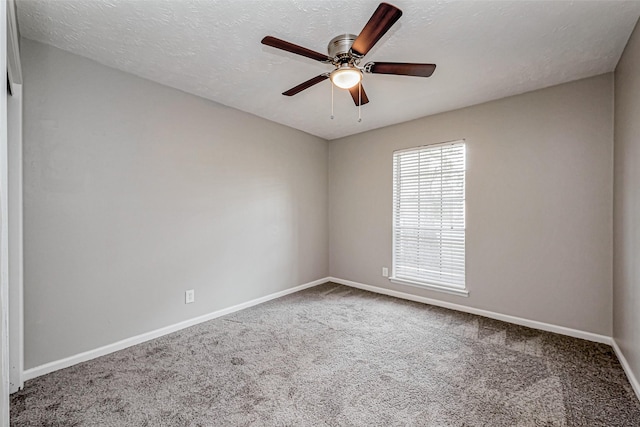 carpeted empty room featuring a ceiling fan, baseboards, and a textured ceiling