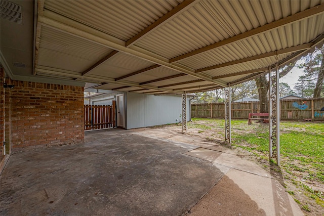 view of patio featuring an attached carport and fence