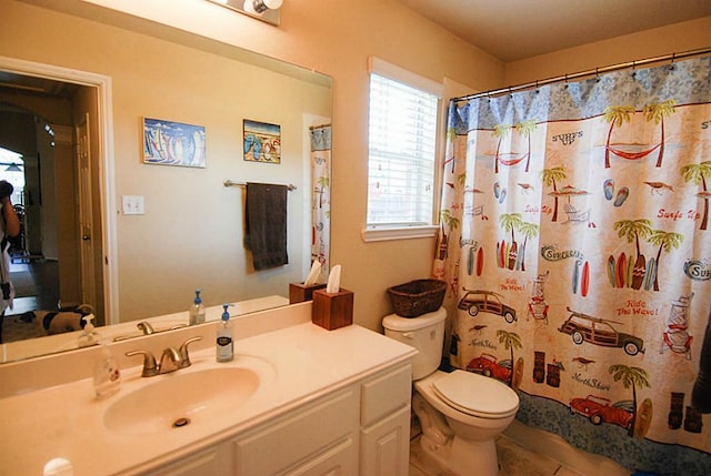 bathroom featuring toilet, vanity, and a shower with shower curtain