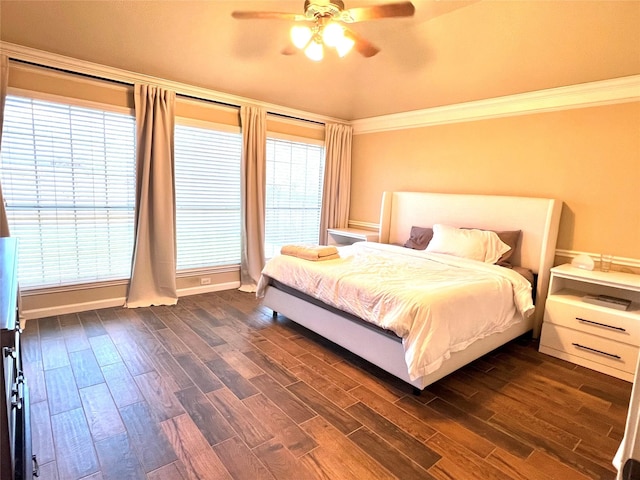 bedroom with ceiling fan, ornamental molding, and dark wood-style flooring