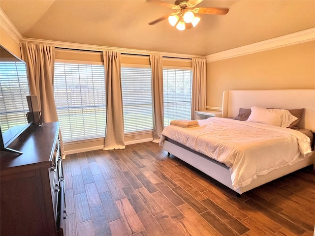 bedroom with a ceiling fan, ornamental molding, and dark wood-style flooring