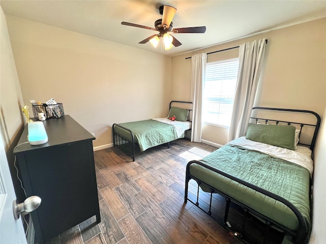 bedroom with wood finished floors, baseboards, and ceiling fan