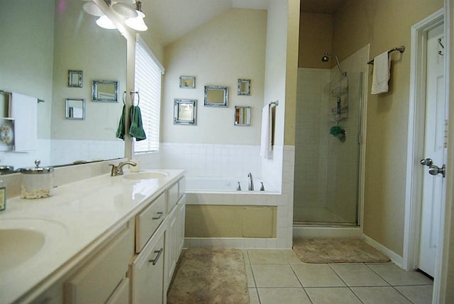 bathroom featuring lofted ceiling, a stall shower, a sink, tile patterned floors, and a bath