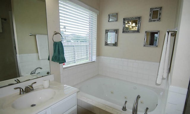 full bath featuring vanity and a whirlpool tub