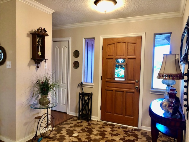 foyer featuring a wealth of natural light, a textured ceiling, crown molding, and baseboards