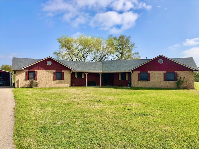 ranch-style house featuring brick siding and a front yard