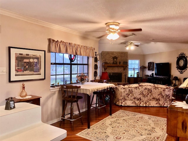 dining area with dark wood-type flooring, a ceiling fan, visible vents, and ornamental molding