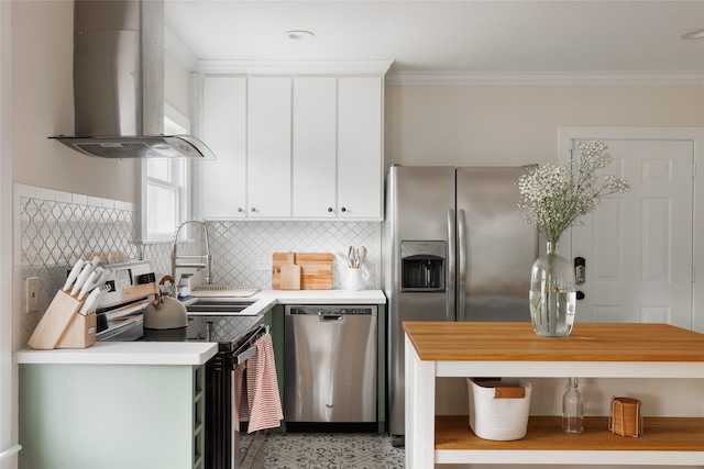 kitchen featuring a sink, range hood, stainless steel appliances, crown molding, and light countertops