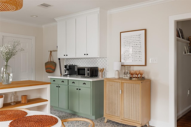 bar with stainless steel microwave, backsplash, visible vents, baseboards, and ornamental molding