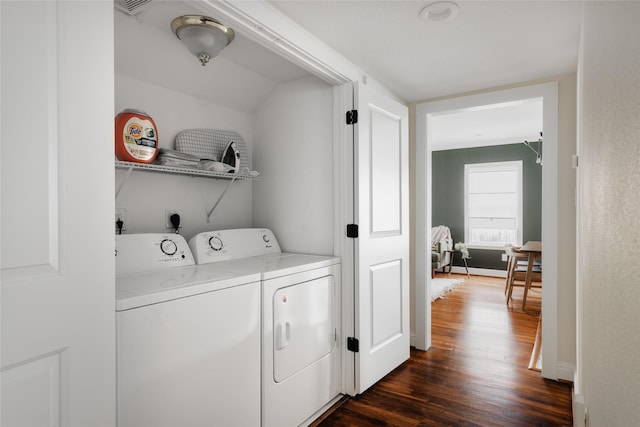 laundry area with dark wood-style floors, baseboards, washing machine and dryer, and laundry area