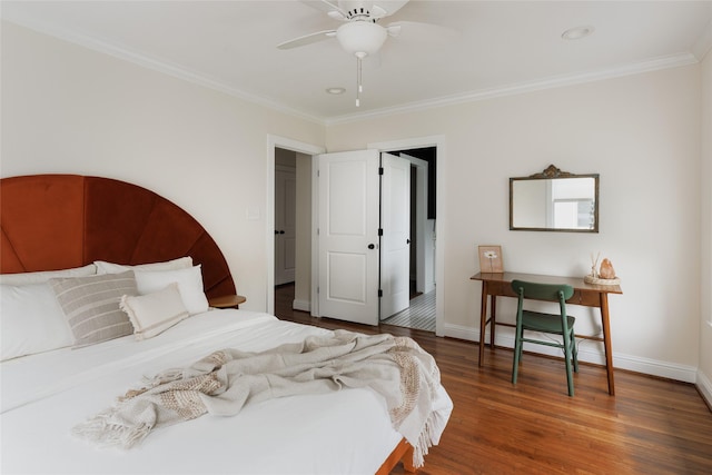 bedroom with baseboards, wood finished floors, and crown molding