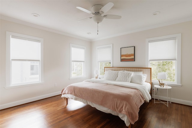 bedroom featuring baseboards, wood-type flooring, and ornamental molding