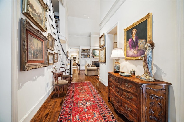 hall featuring stairway, wood finished floors, and baseboards