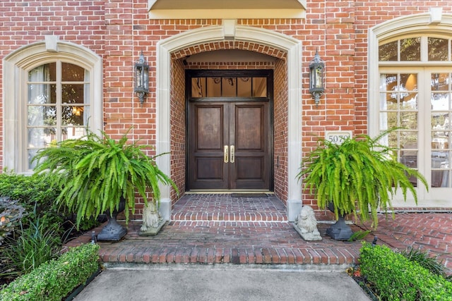 entrance to property featuring brick siding