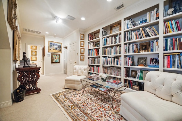 living area featuring visible vents, carpet flooring, baseboards, and ornamental molding