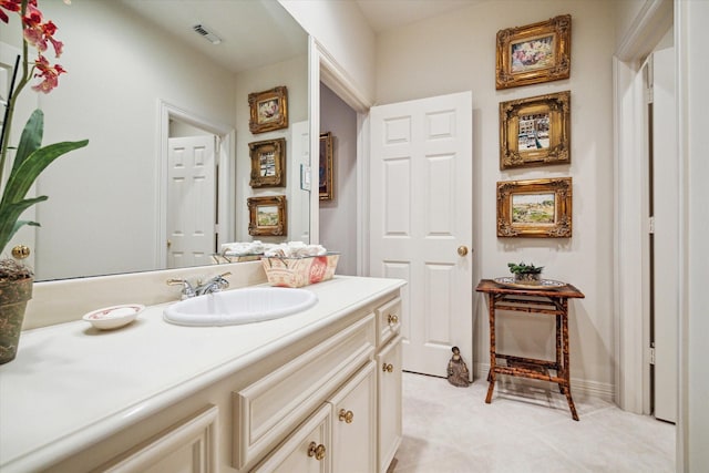 bathroom featuring tile patterned floors, visible vents, baseboards, and vanity