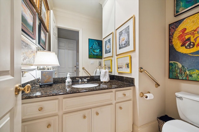 half bath with vanity, toilet, and crown molding