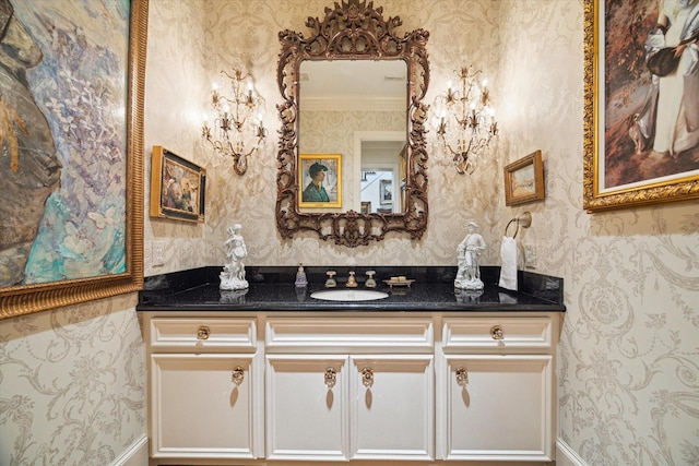 bathroom with wallpapered walls, vanity, and ornamental molding