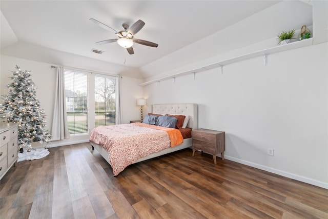 bedroom with visible vents, ceiling fan, baseboards, dark wood finished floors, and vaulted ceiling