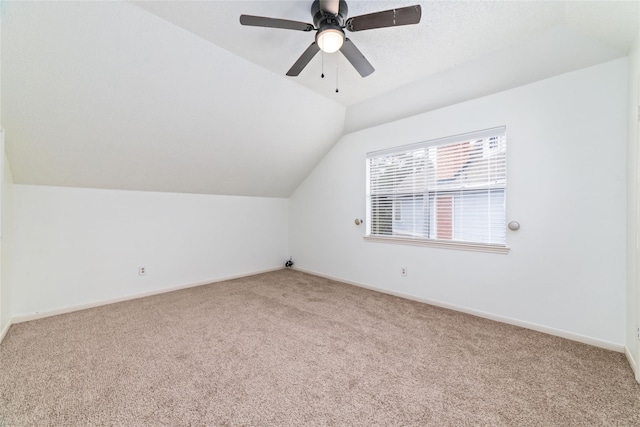 bonus room featuring carpet flooring, ceiling fan, baseboards, and lofted ceiling