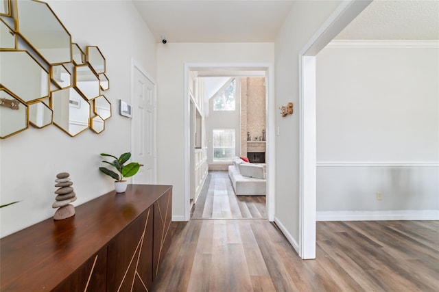 corridor featuring baseboards and wood finished floors