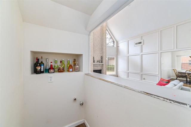 clothes washing area with visible vents, baseboards, and a fireplace