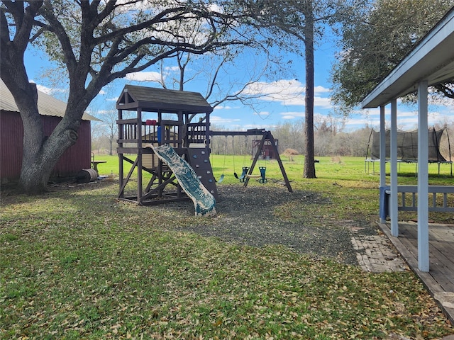 view of yard featuring a playground and a trampoline