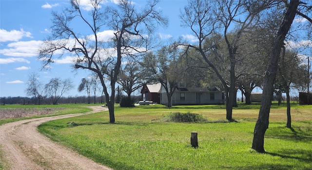 surrounding community featuring a yard and driveway