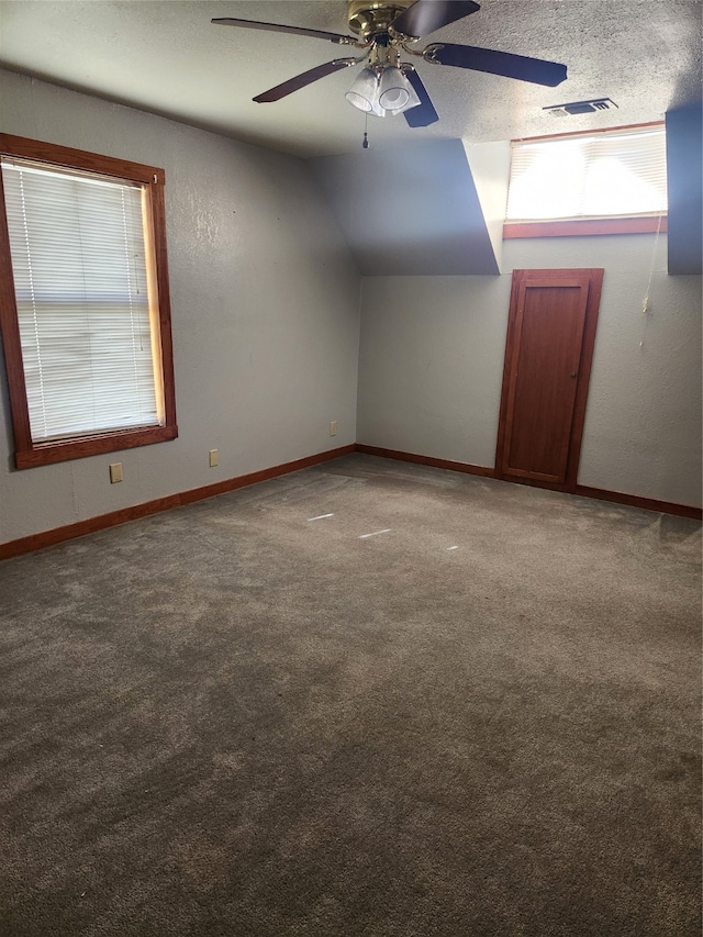 bonus room featuring baseboards, visible vents, a ceiling fan, and carpet