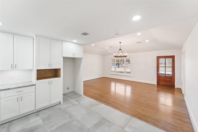 kitchen featuring visible vents, a chandelier, decorative backsplash, recessed lighting, and white cabinets