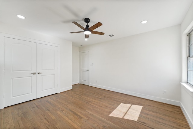 unfurnished bedroom with recessed lighting, visible vents, baseboards, and wood finished floors