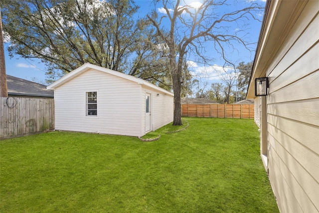 view of yard with an outbuilding and a fenced backyard