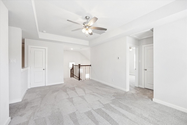 carpeted empty room featuring a ceiling fan and baseboards