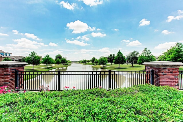 view of yard featuring fence and a water view