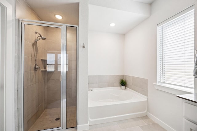 bathroom featuring a bath, a shower stall, and a healthy amount of sunlight