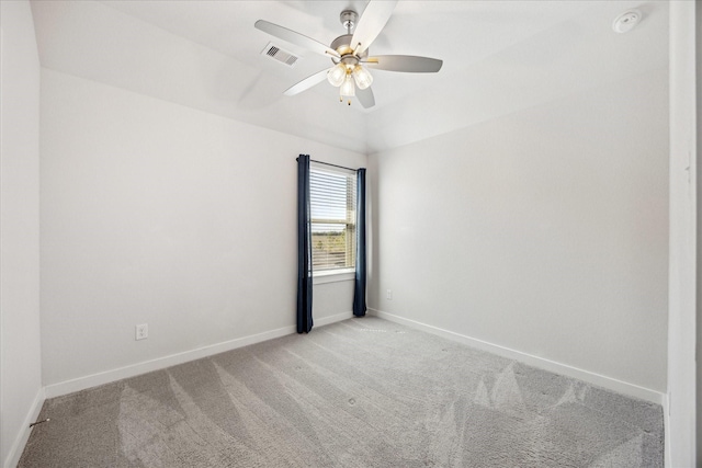 empty room featuring visible vents, light carpet, baseboards, lofted ceiling, and ceiling fan