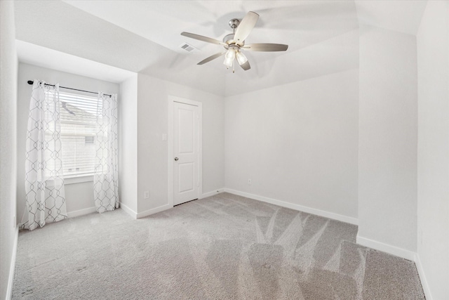 empty room with visible vents, baseboards, a ceiling fan, and carpet flooring