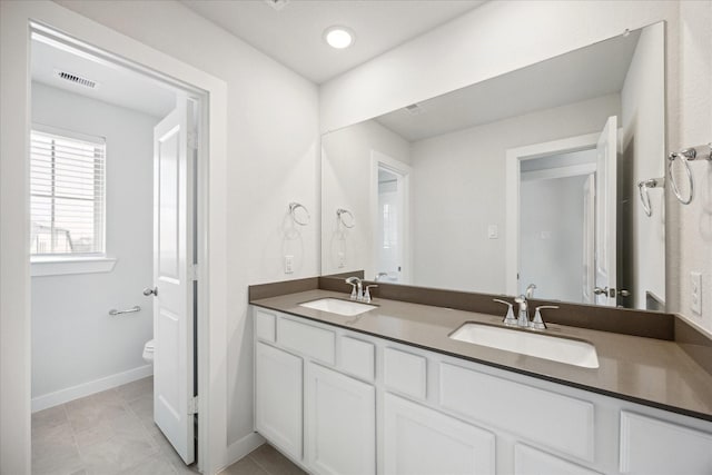 full bathroom featuring double vanity, visible vents, toilet, and a sink