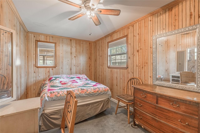 bedroom featuring wooden walls, ornamental molding, and carpet floors