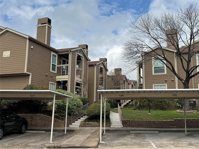 covered parking lot featuring stairway