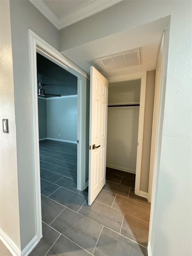 corridor featuring baseboards and ornamental molding