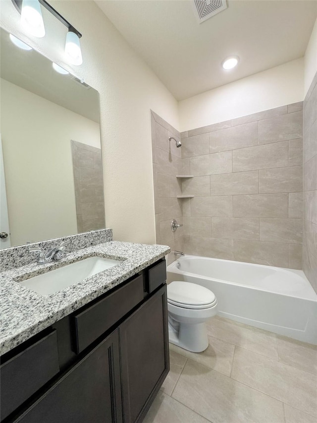 bathroom with tile patterned floors, visible vents, toilet, bathing tub / shower combination, and vanity