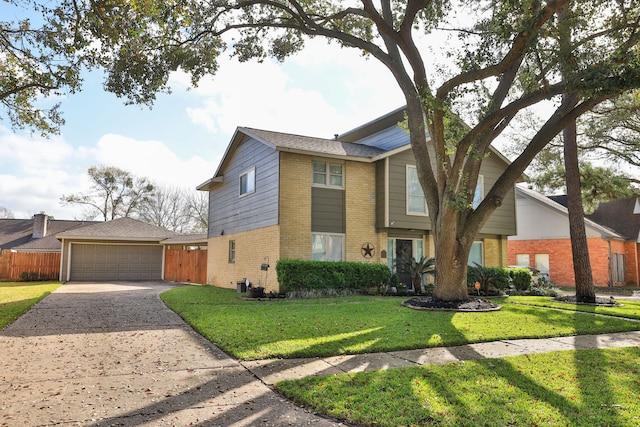 view of front of home with brick siding, a detached garage, a front lawn, and fence