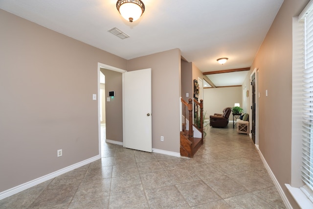 interior space featuring stairway, light tile patterned floors, baseboards, and visible vents