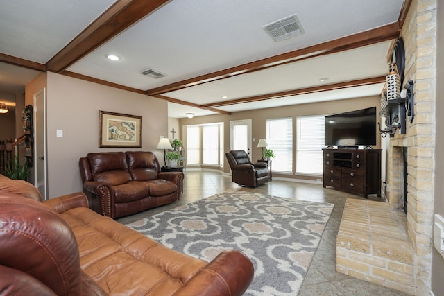 living room with recessed lighting, visible vents, a brick fireplace, and beamed ceiling