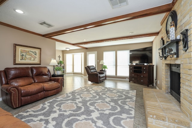 living room featuring tile patterned floors, visible vents, beamed ceiling, and a brick fireplace