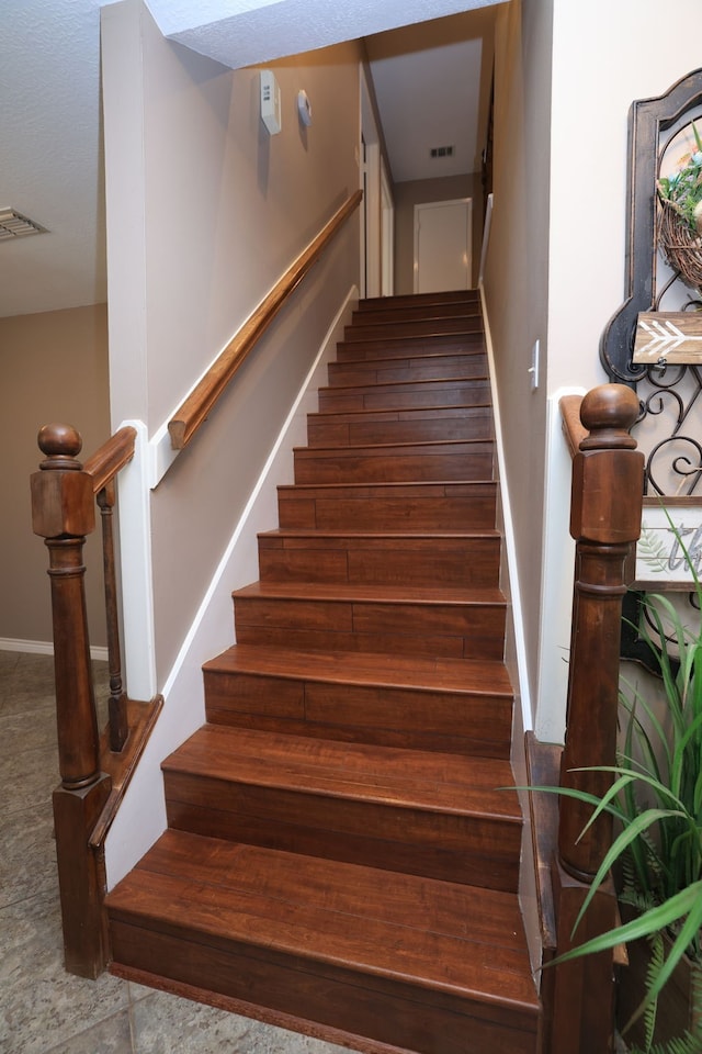 stairway featuring visible vents